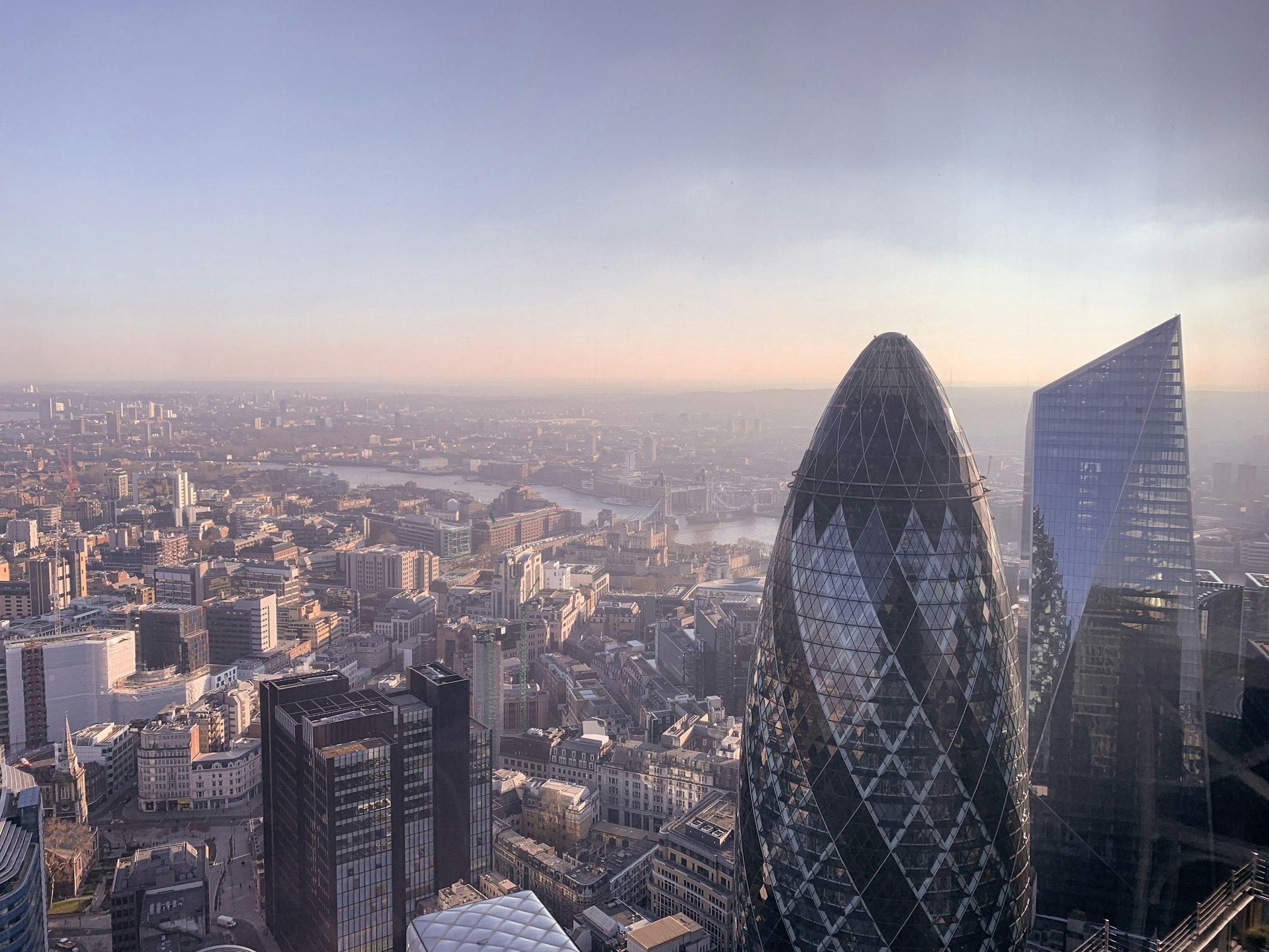 The Gherkin and neighbouring towers in the City of London in soft morning haze.